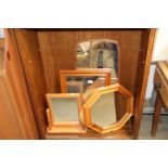 A teak framed wall mirror and three other mirrors