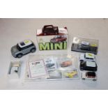 A quantity of Corgi and other Mini Cooper models, Mini Cooper collectors cards, a silver teaspoon