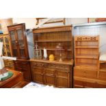 An oak dresser raised on cupboard base fitted two