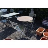 A metal garden table and pair of metal and wood fo