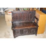 A carved oak settle