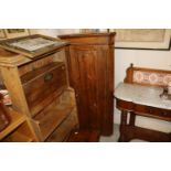 A stained pine corner cupboard