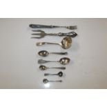 A silver strainer; various silver spoons; silver h