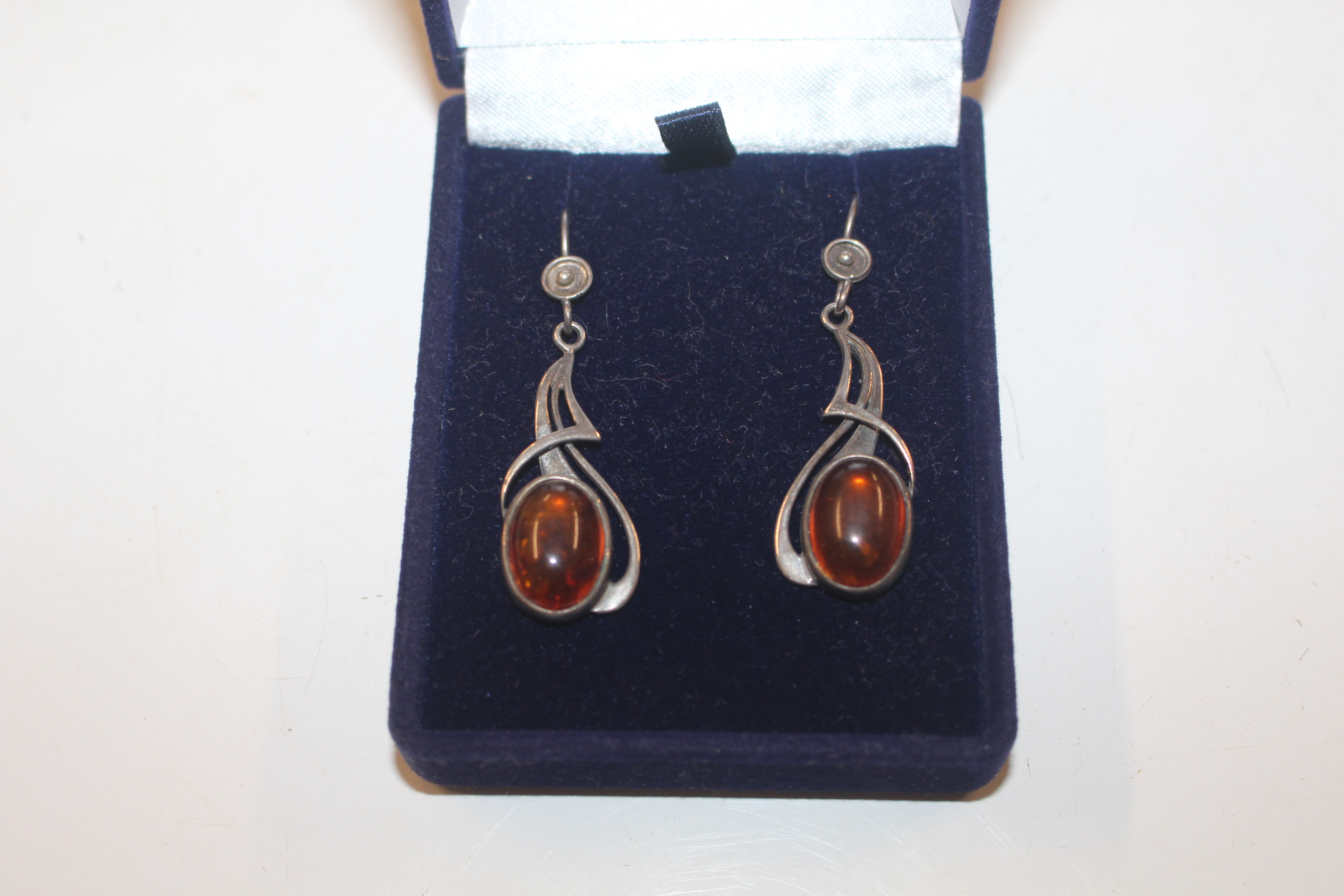 A pair of silver and amber set ear-rings