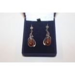 A pair of silver and amber set ear-rings