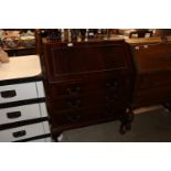 A mahogany bureau fitted three long drawers, raise