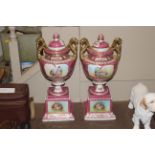 A pair of pink and gilt porcelain vases on stands