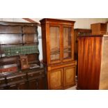 A Victorian bookcase raised on cupboard base fitte