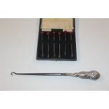 A set of six silver cocktail sticks and a silver h