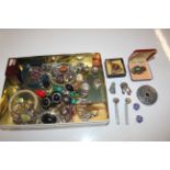 A tin of various costume jewellery