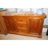 An oak sideboard fitted three central drawers, fla