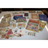 A box of various collector's cards, stamp albums e