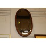 A 19th Century oval bevel edged wall mirror with chequer band inlay