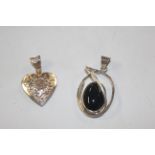 A large Sterling silver and black onyx pendant; an