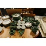 A collection of green glazed cabbage leaf dinnerwa