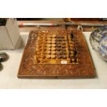 A chess set; draft pieces and carved wooden chess