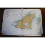 A box of various sea charts and maps