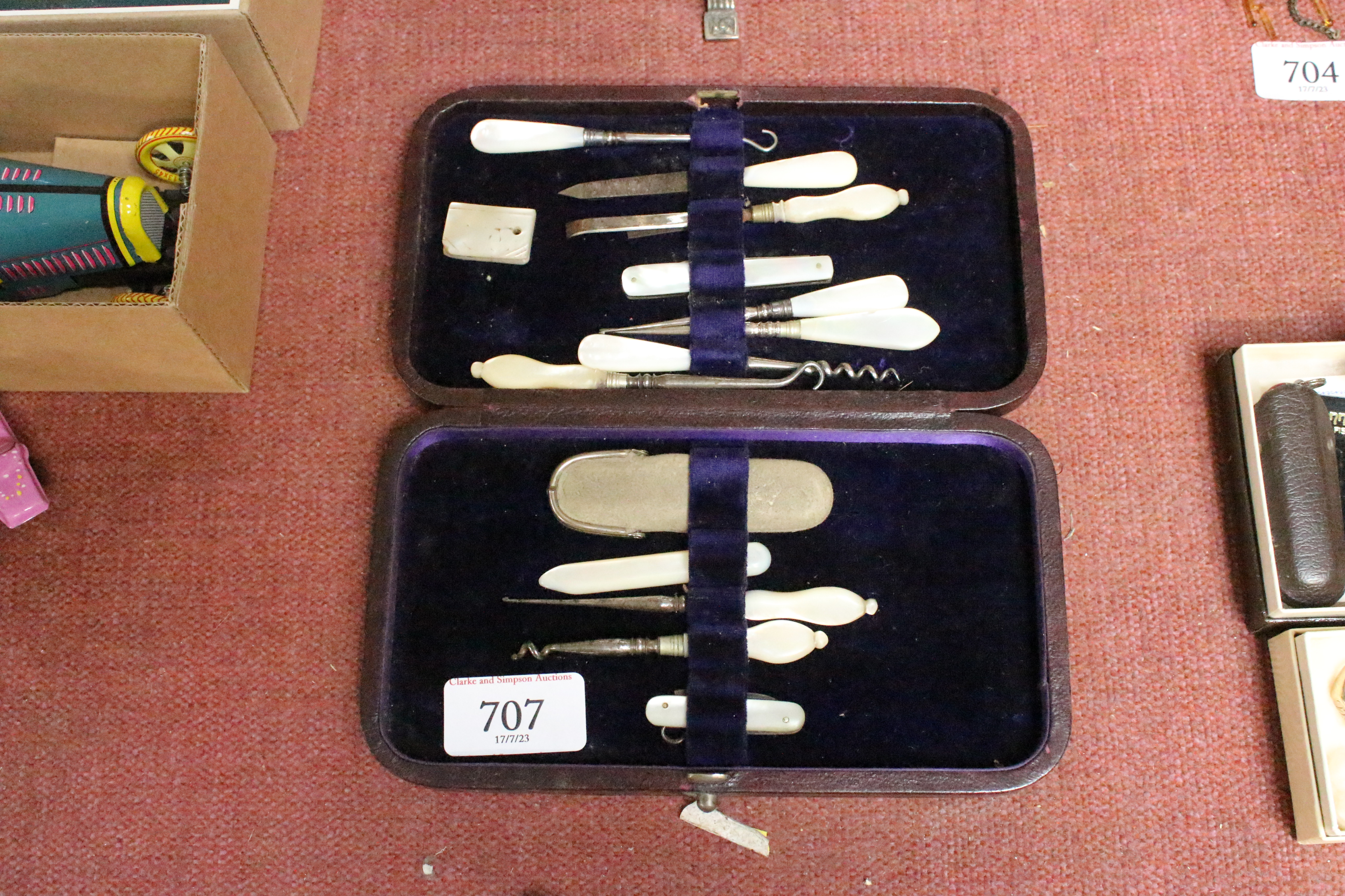 A collection of cased Mother of Pearl handled mani