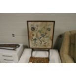 A floral embroidered fire screen/tilt topped table