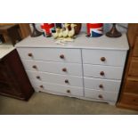 A painted pine effect chest fitted four short and