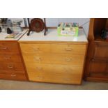 A teak and laminate chest fitted two short and thr