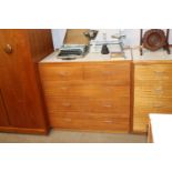 A teak and laminate chest fitted two short and thr