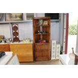 An Ercol upright corner cabinet