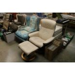 A cream leather upholstered Stress Less adjustable armchair and footstool