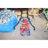 A pair of axle stands and a folding metal sack tro