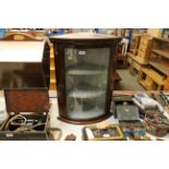 A mahogany and glazed bow fronted corner cabinet