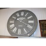 A large circular wall clock marked Kensington Stat