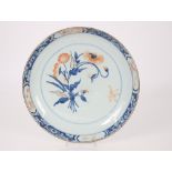A large 18th Chinese porcelain underglaze blue and coral saucer dish, the centre painted with a