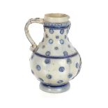 A Westerwald stoneware baluster jug, decorated in blue salt glaze with raised pruntz and central