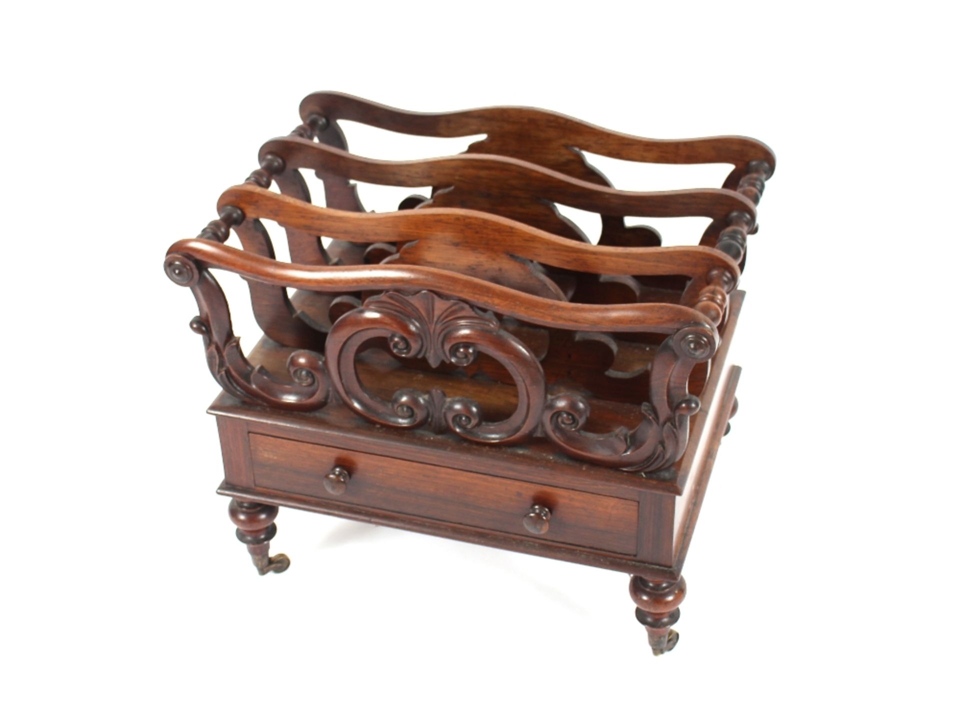 A 19th Century rosewood Canterbury, pierced and scrolled decoration, single drawer to base, raised