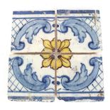 Four 18th Century Spanish blue and yellow wall tiles, 14cm sq.