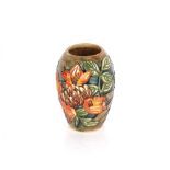 A Moorcroft floral decorated vase, 13cm high