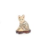 A 19th Century Persian tin glazed pottery model of a cat, full of expression, naïvely modelled,