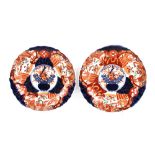 A pair of Japanese Imari scallop bordered plates; a pair of Victorian stone china plates decorated