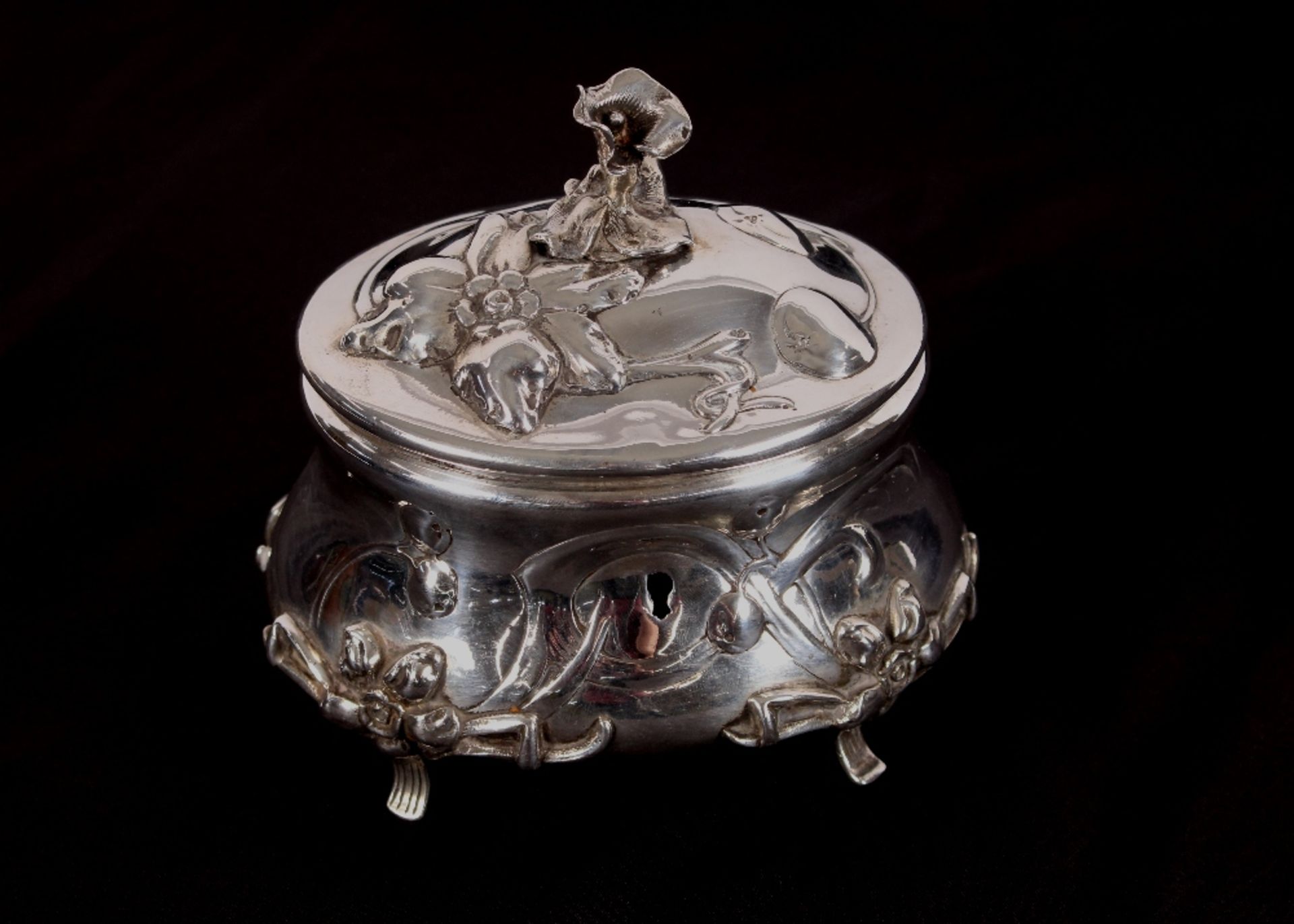 A continental white metal hinged casket, the lid surmounted by a flower finial, raised foliate heads - Image 2 of 2