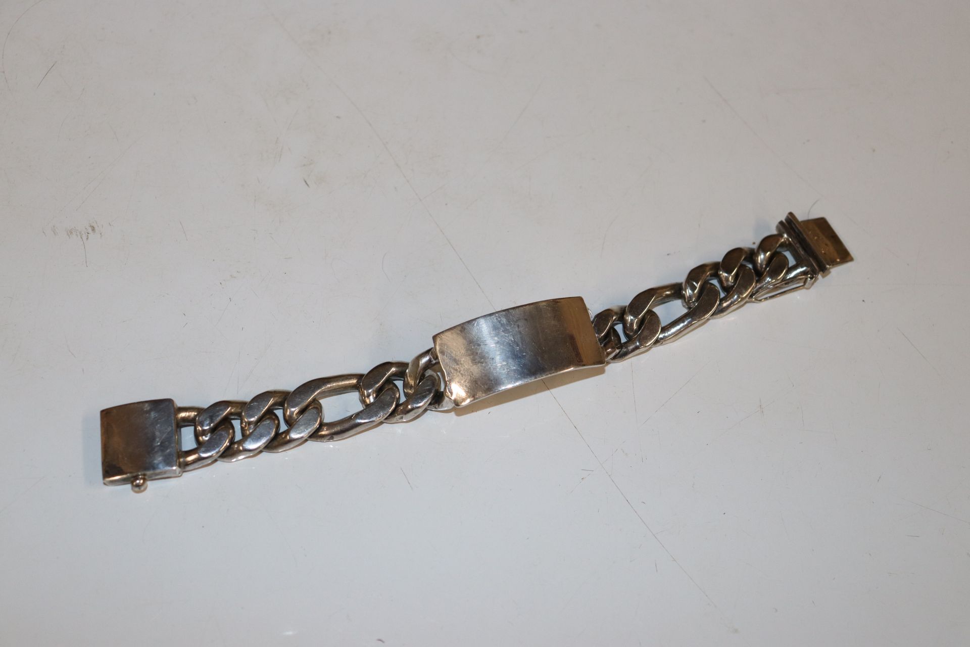 A large white metal marked 925 identity bracelet,