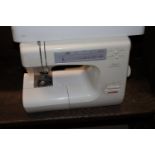 A Janome electric sewing machine in carry case