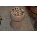 A reproduction Guinness advertising cork / stool