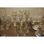 A quantity of glass candlesticks AF