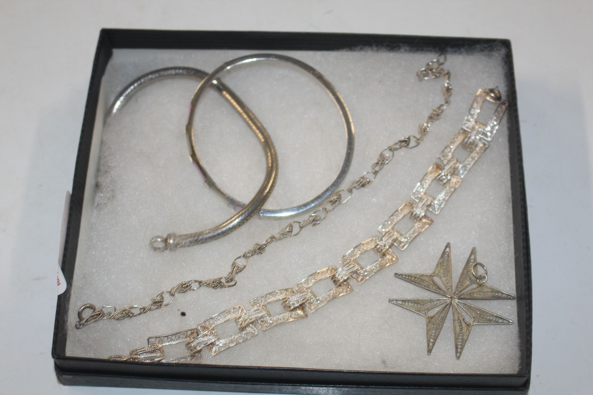 A box of five silver and white metal bracelets, ap