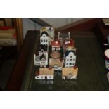 A quantity of model cottages and KLM decanters