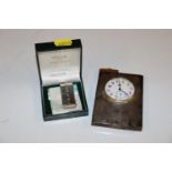 A silver cased travelling clock and a silver money