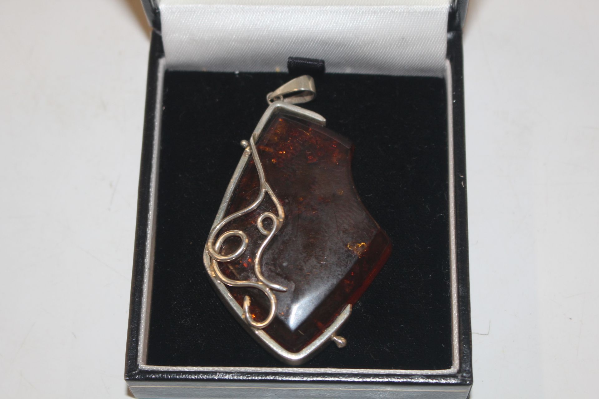 Hallmarked Sterling silver and amber pendant, appr