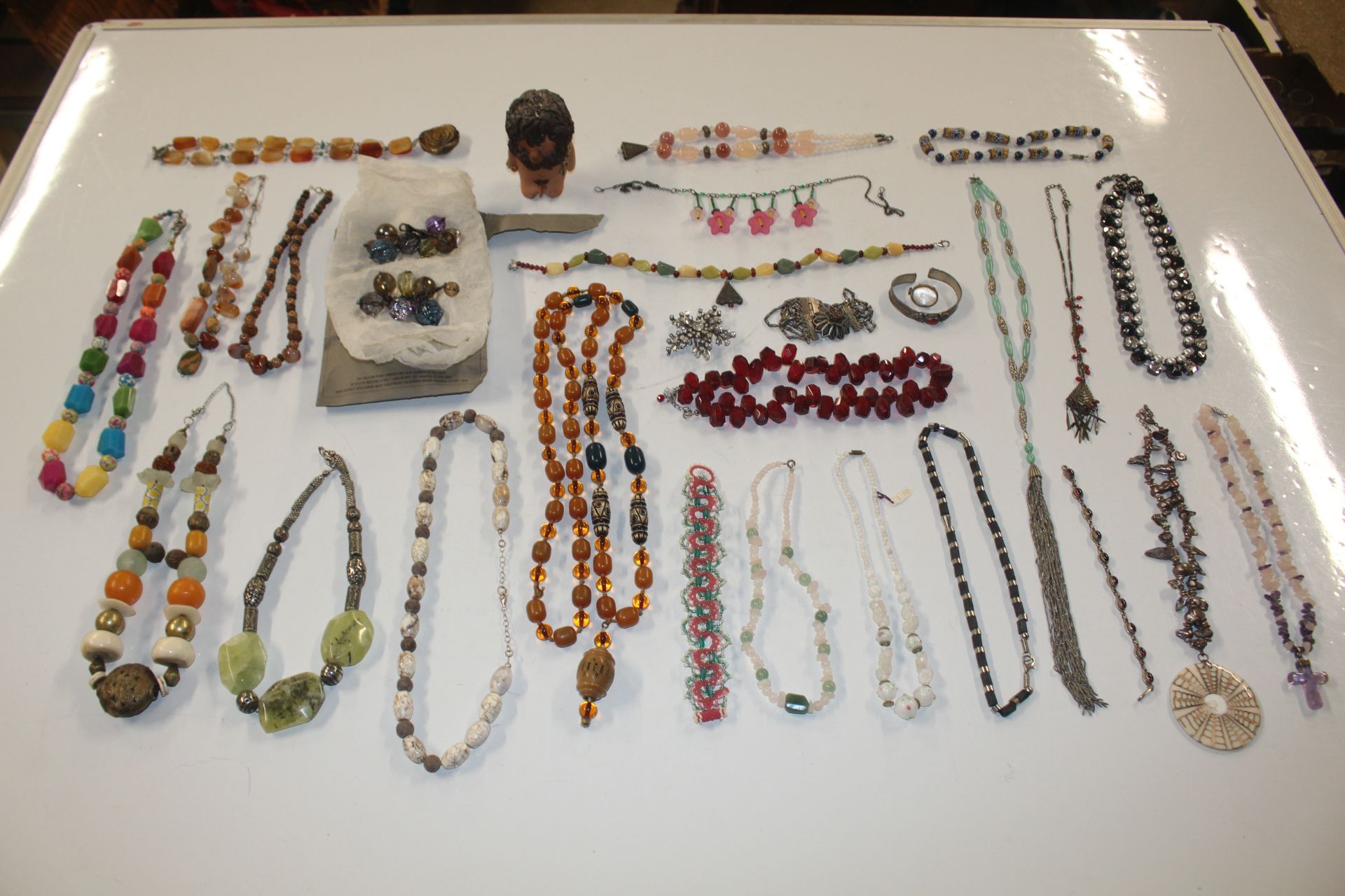 A box of various beaded jewellery