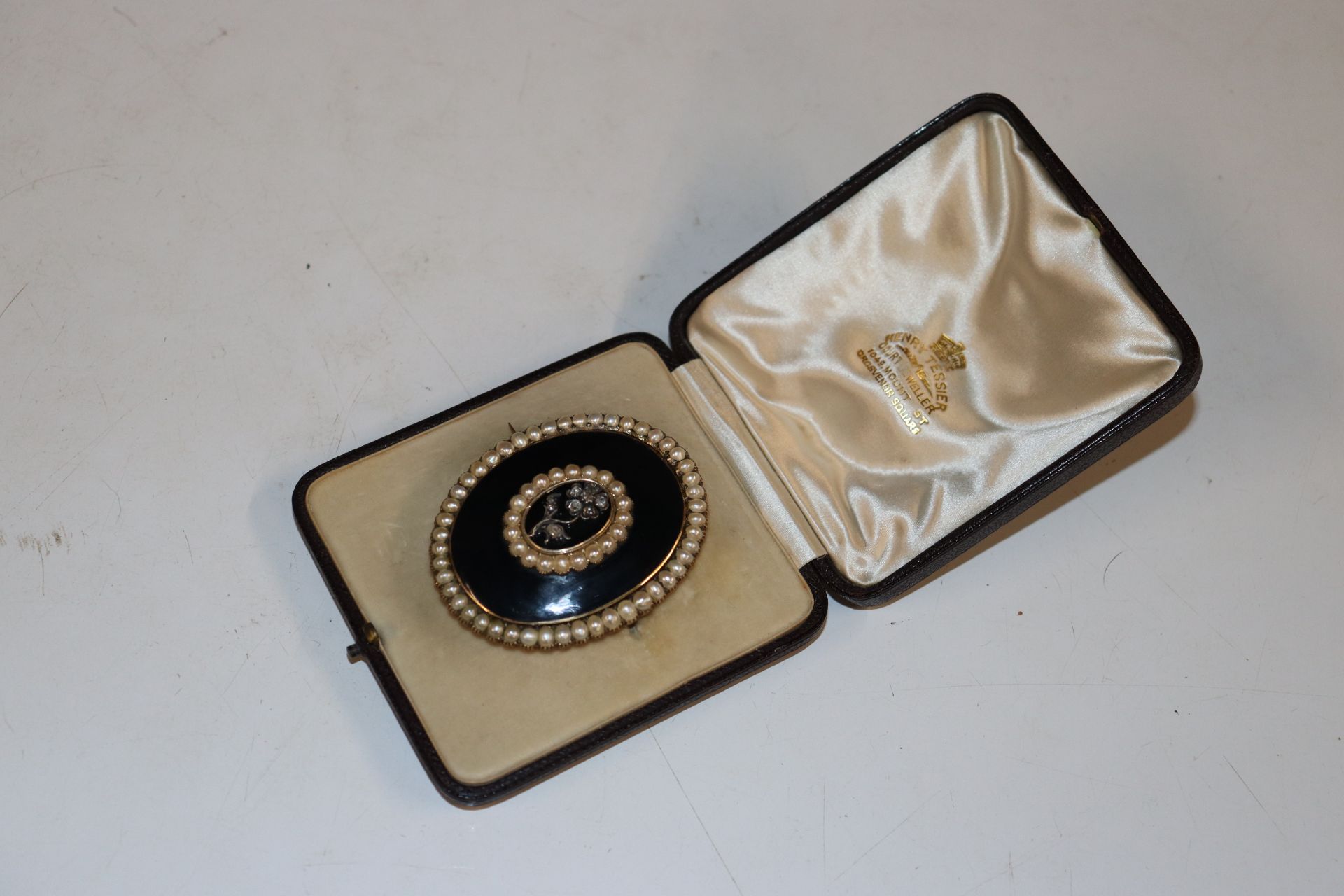 A yellow metal mourning brooch set with diamonds