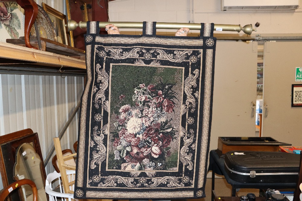 A tapestry effect wall hanging with pole